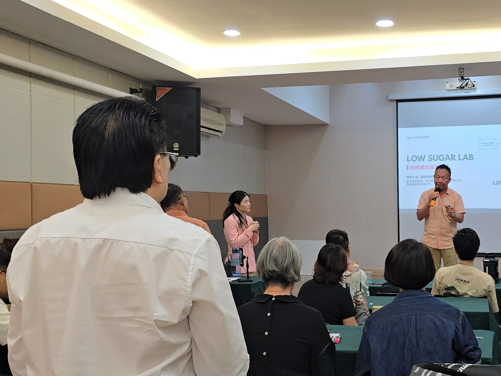 Wide view of a live DCK client workshop with trainer and participants