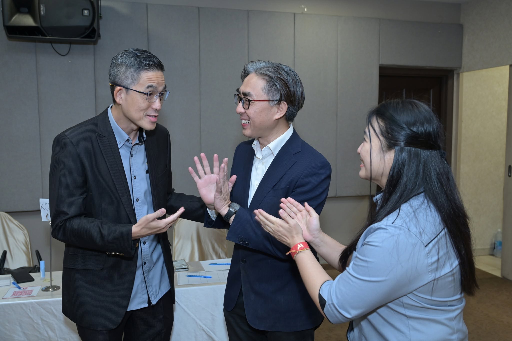 Members in conversation and applause during event registration